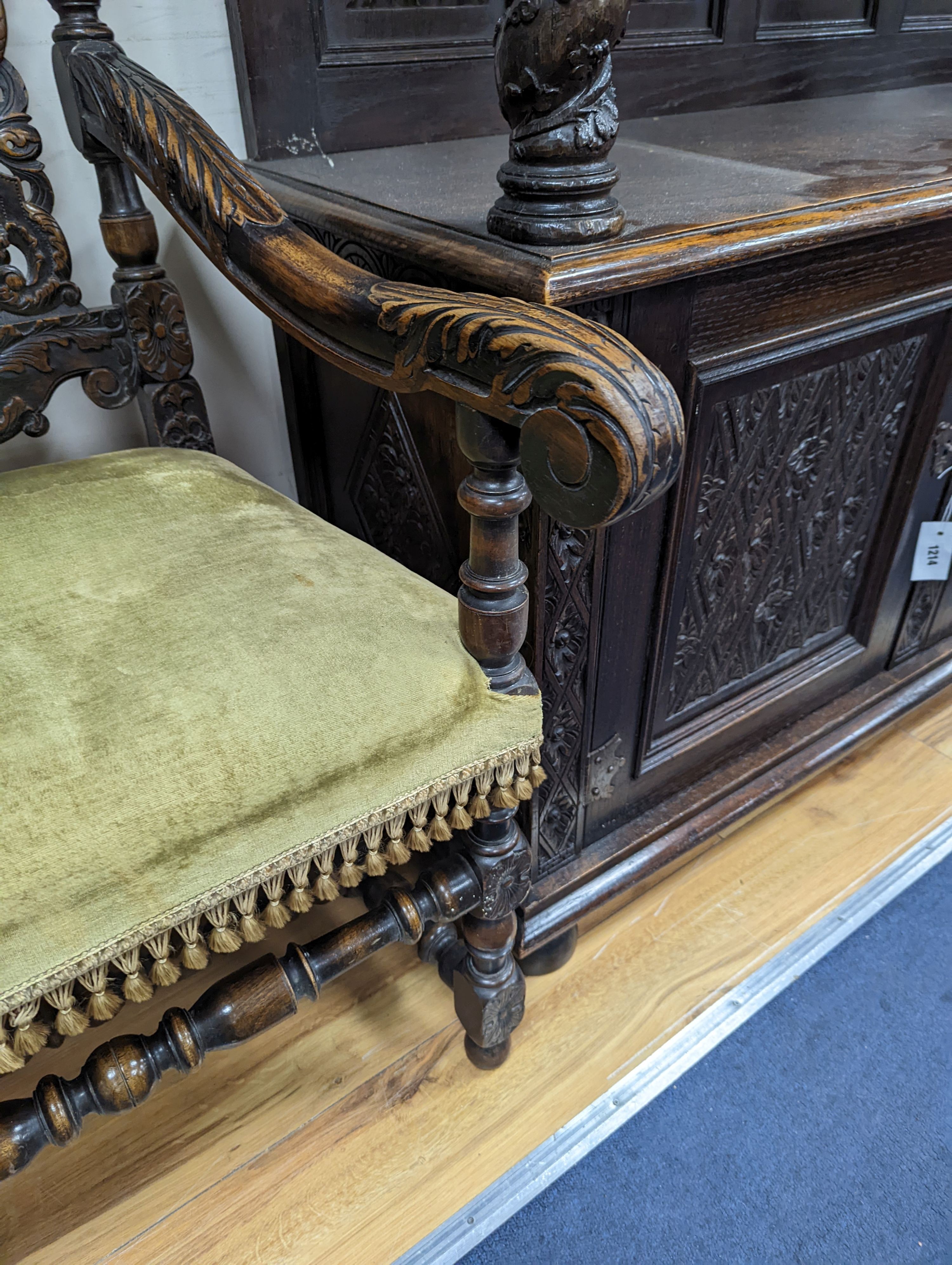 A pair Charles II style carved oak elbow chairs with upholstered seats on turned underframes, width 63cm, depth 54cm, height 133cm